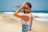 a woman in a tie dye bikini on the beach