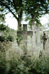 a cemetery with a cross in the middle of it