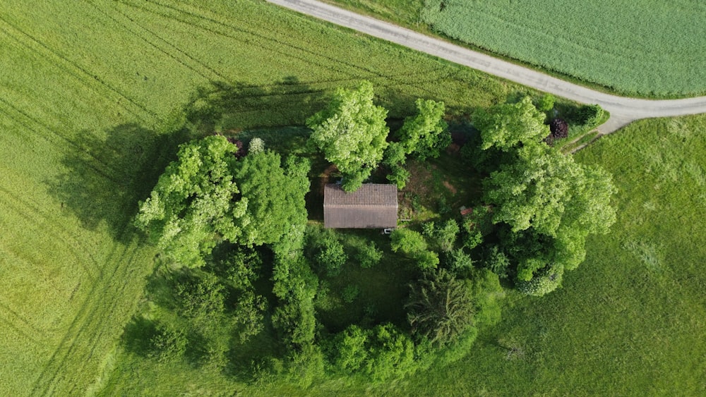 an aerial view of a house in the middle of a field