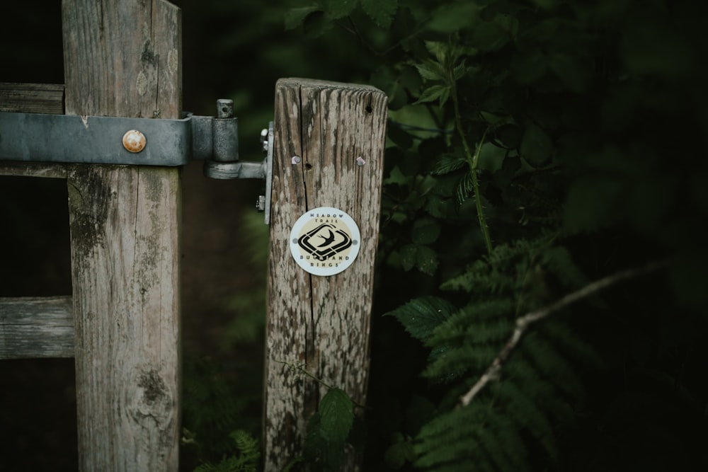 a close up of a wooden gate with a sticker on it