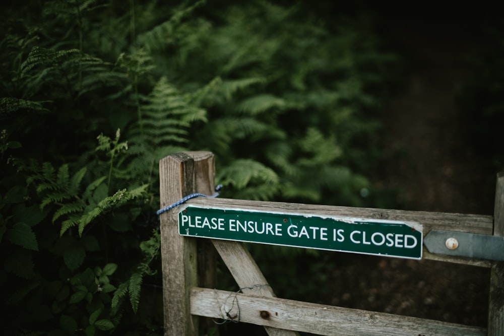 a close up of a sign on a wooden fence