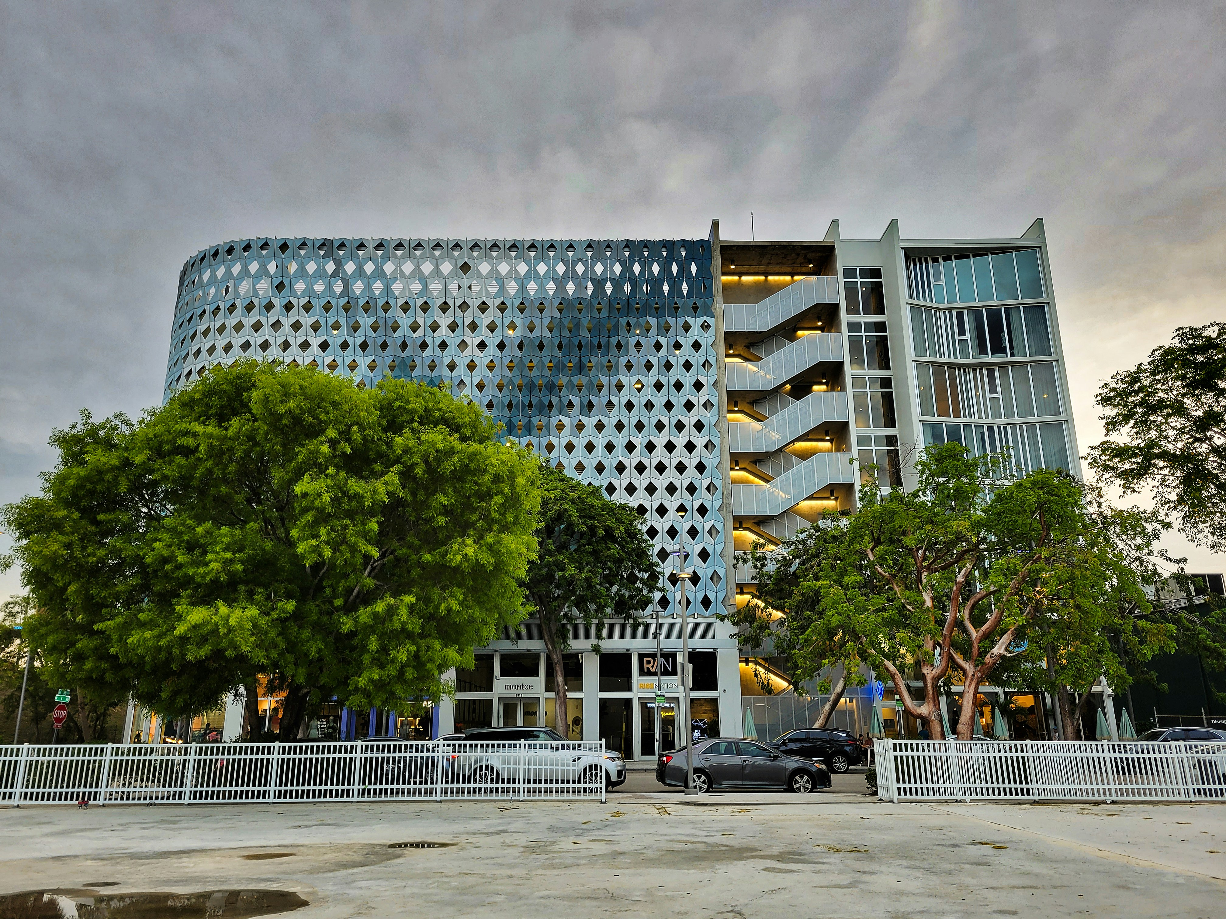 a car parked in front of a tall building
