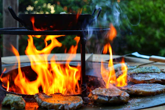 Close-up of a juicy Andean beef steak sizzling on a rustic grill with mountain scenery in the background