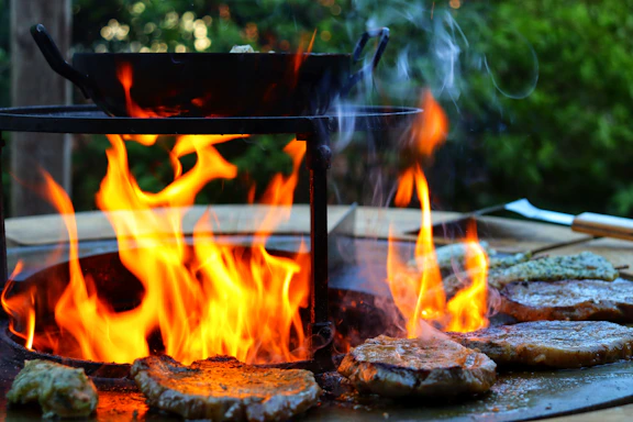 Close-up of a sizzling Florentine steak on a rustic grill with glowing embers.