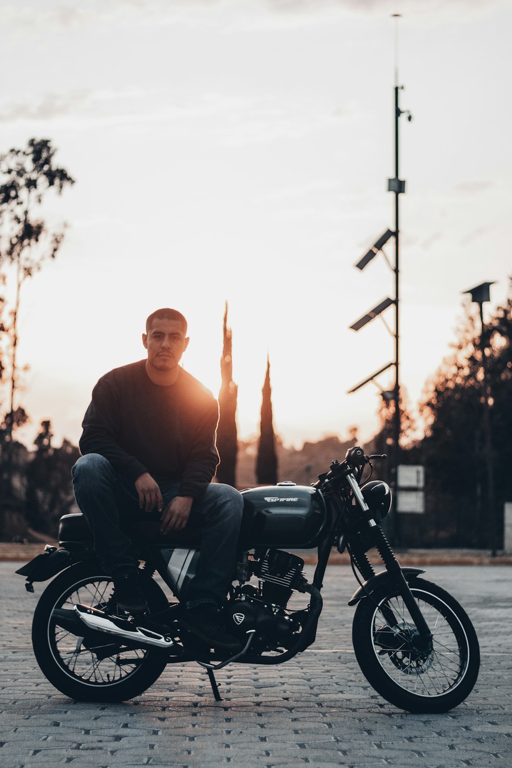 a man sitting on top of a motorcycle