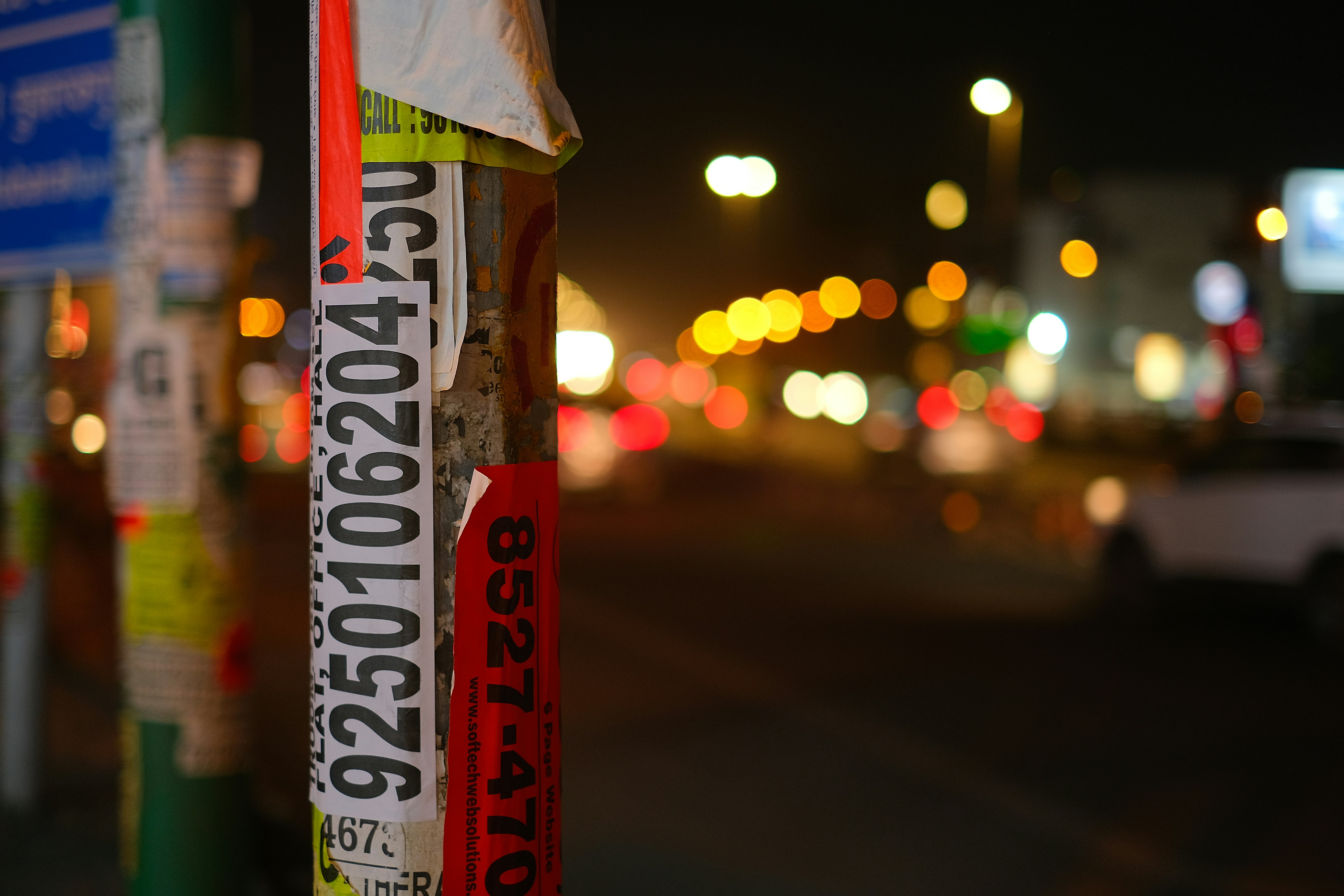 a close up of a pole with a lot of stickers on it