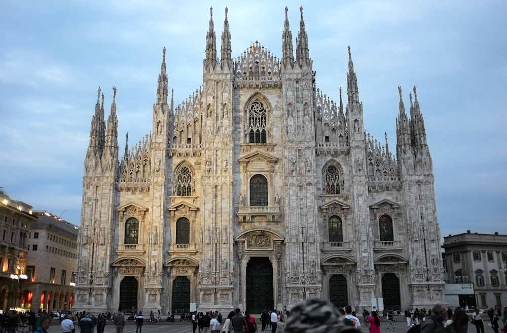 a group of people standing in front of a cathedral