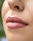 a close up of a woman's lips with a green background