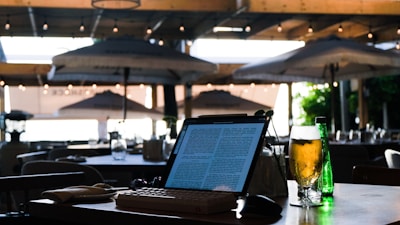 a laptop computer sitting on top of a wooden table