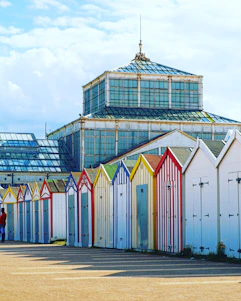 A colorful 1970s style seaside concierge office with retro decor and smiling staff.