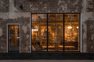 a brick building with a large glass window