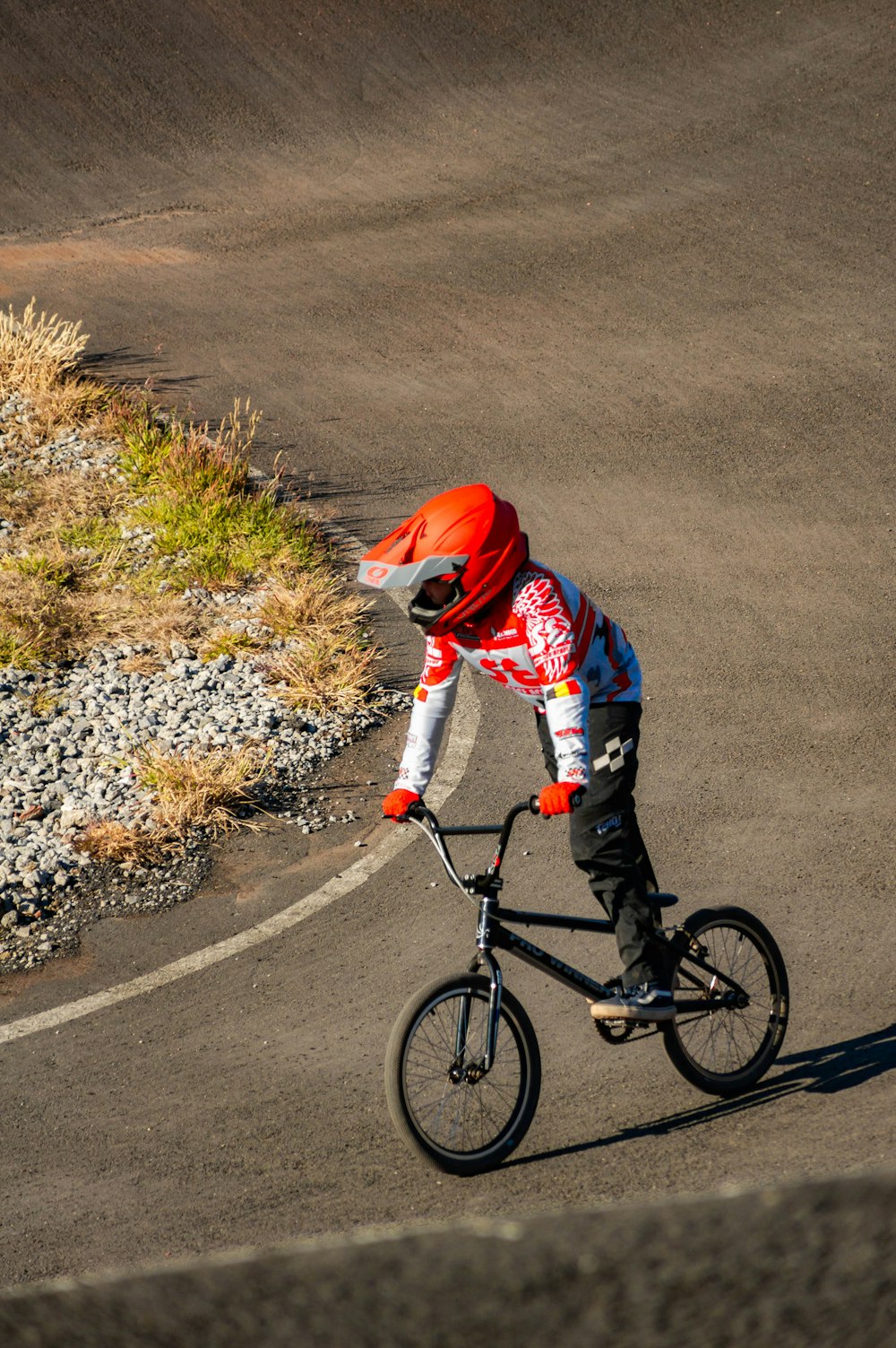 a man riding a bike down a curvy road