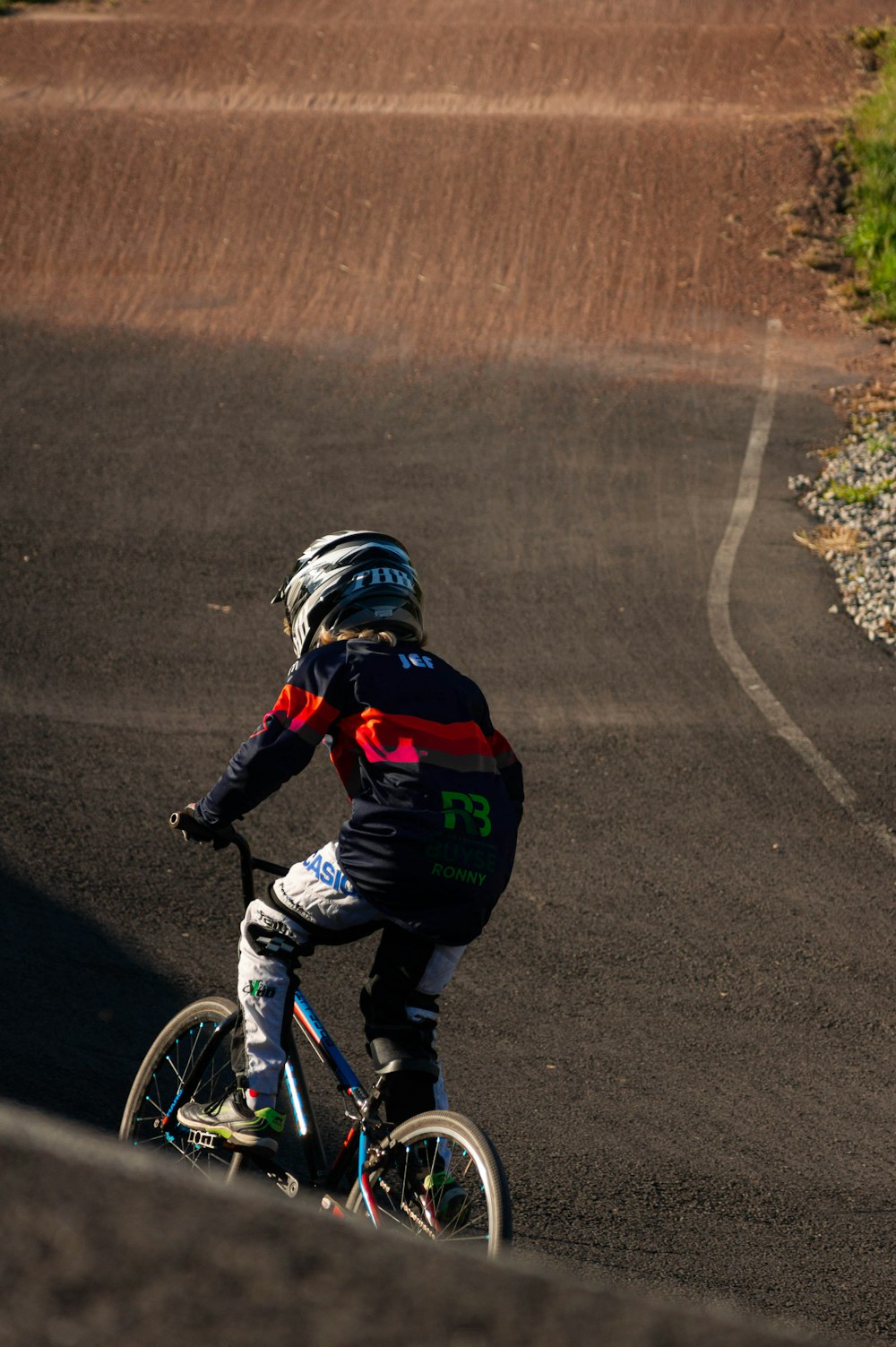 a person riding a bike on a road