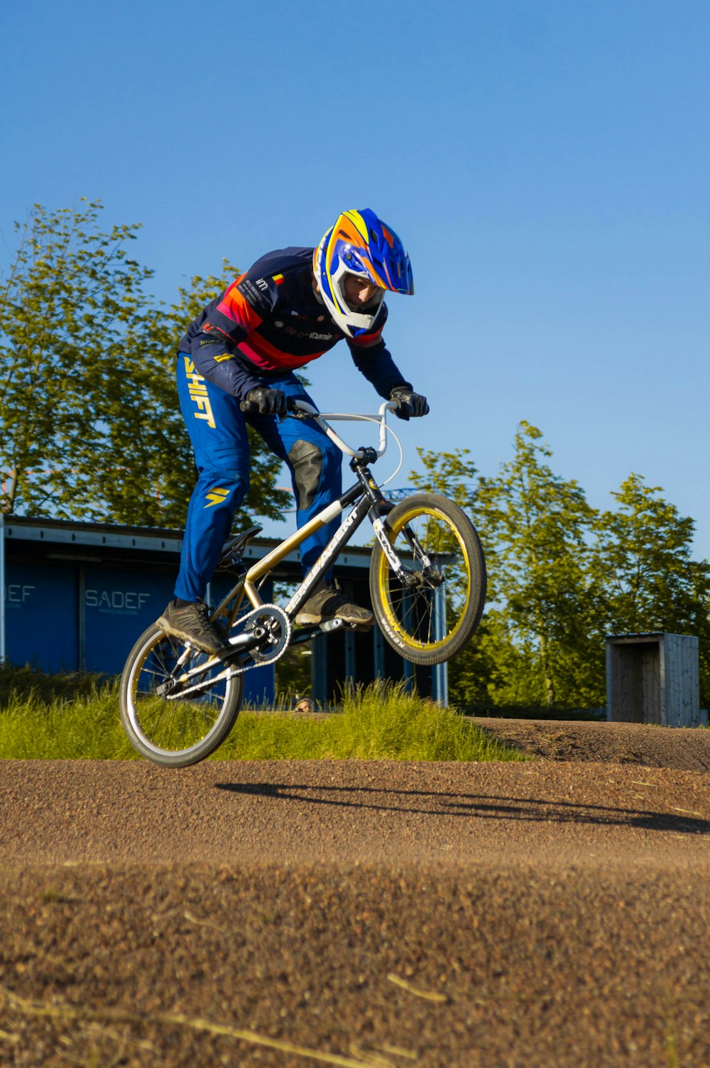 a man riding a bike down a dirt road