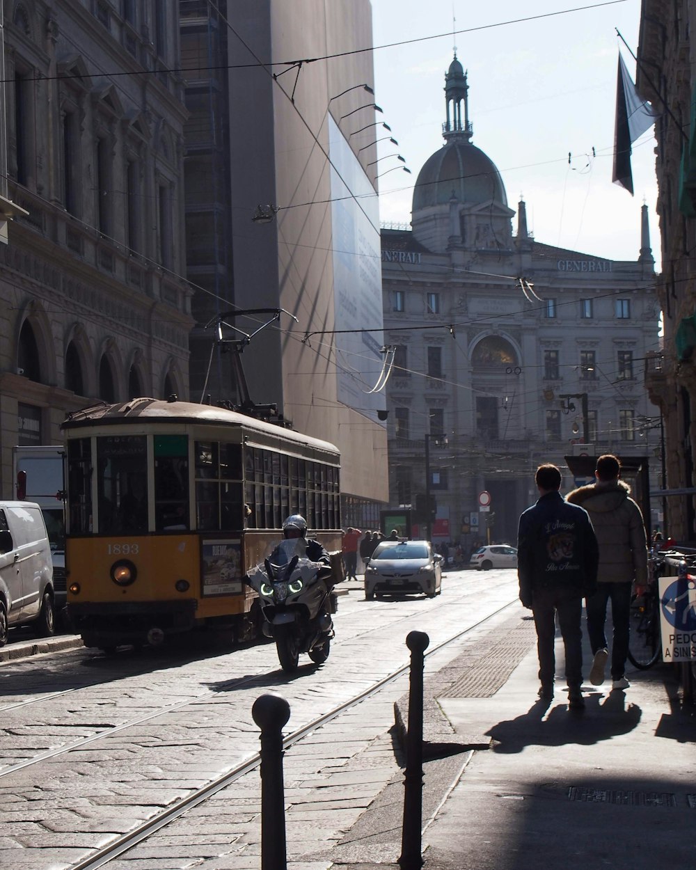 a street scene with a trolley and cars