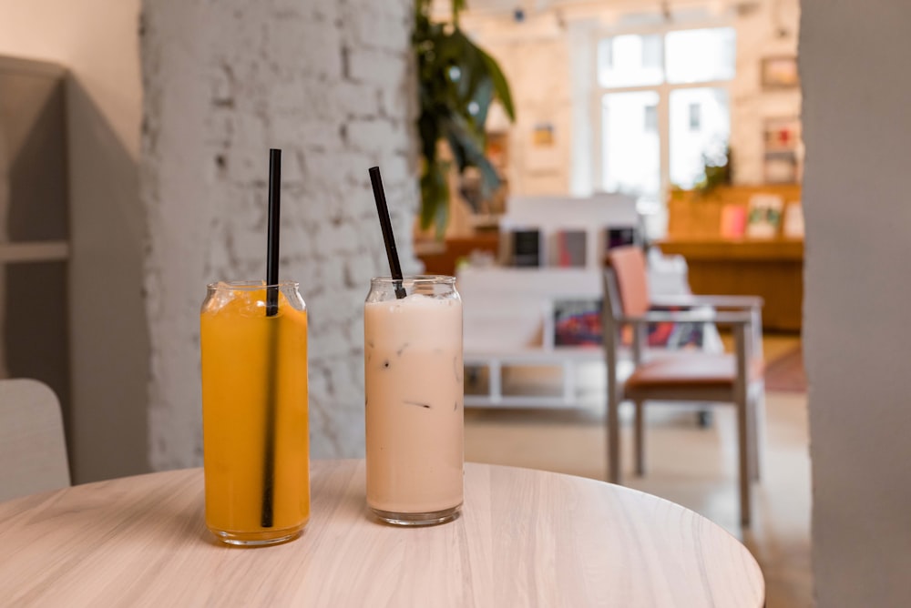 two drinks sitting on a table next to each other