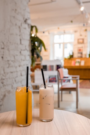 two drinks sitting on top of a wooden table