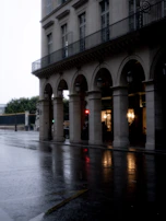 A cinematic still of a rainy city street at night, capturing a quiet, reflective mood.
