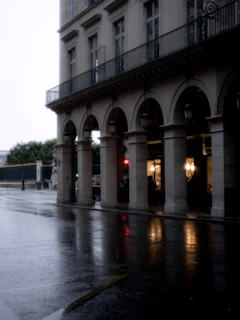 A cinematic still of a rainy city street at night, capturing a quiet, reflective mood.