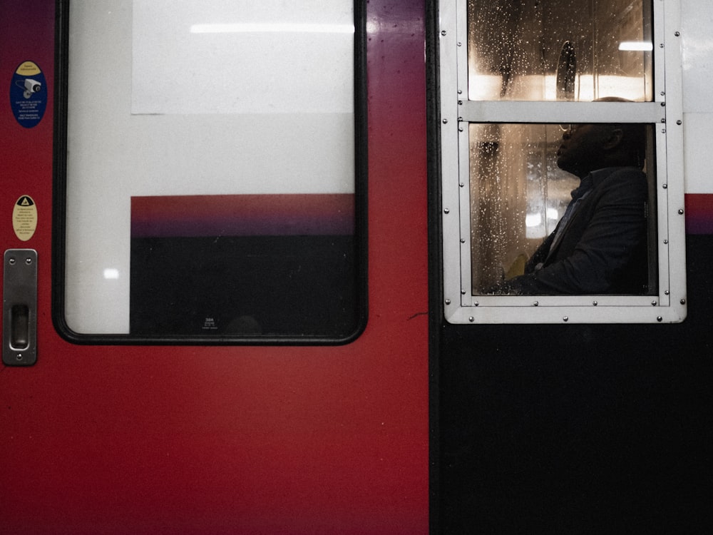 a person looking out of a window on a train