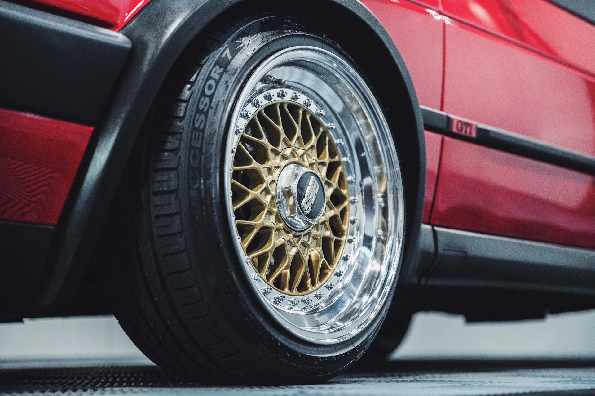 a close up of a tire on a red car