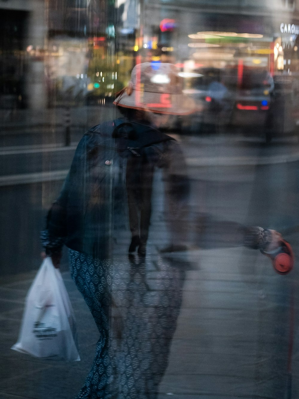 a woman walking down a street holding an umbrella