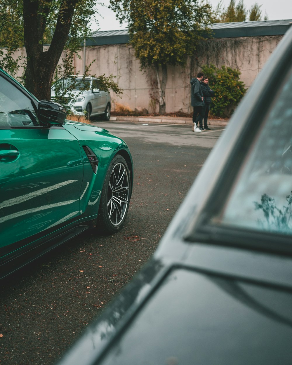 a green sports car parked on the side of the road