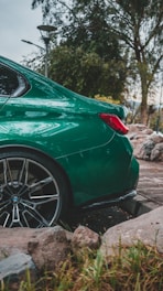 a green sports car parked on the side of the road