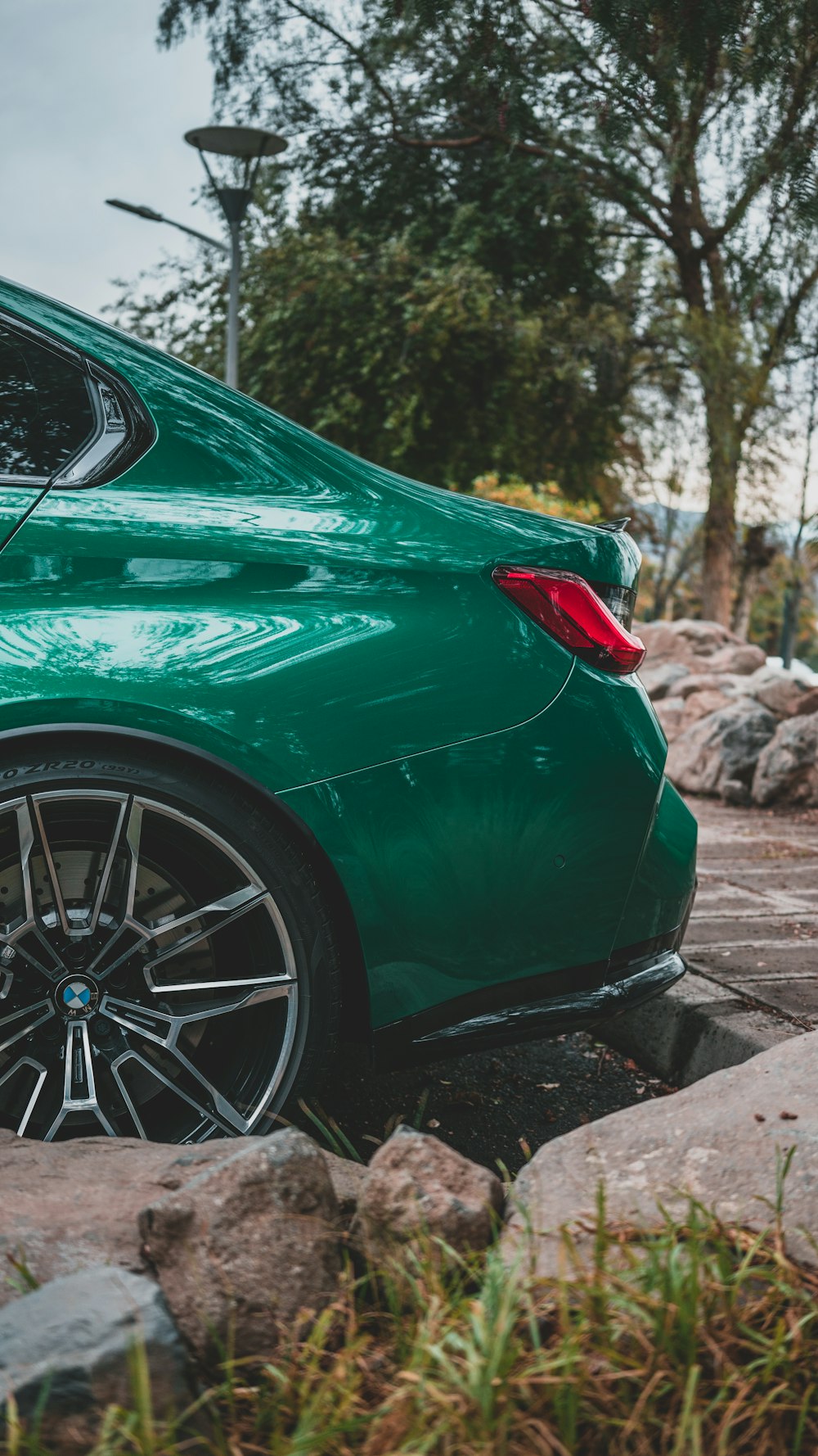 a green sports car parked on the side of the road