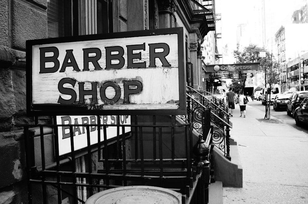 a black and white photo of a barber shop sign