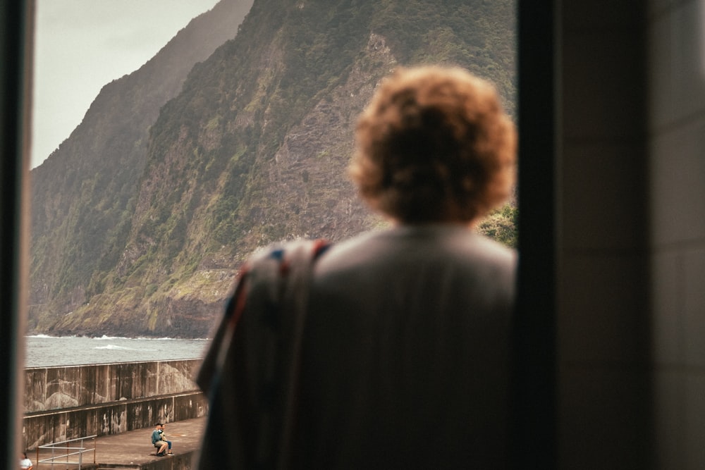 a man standing in front of a mountain