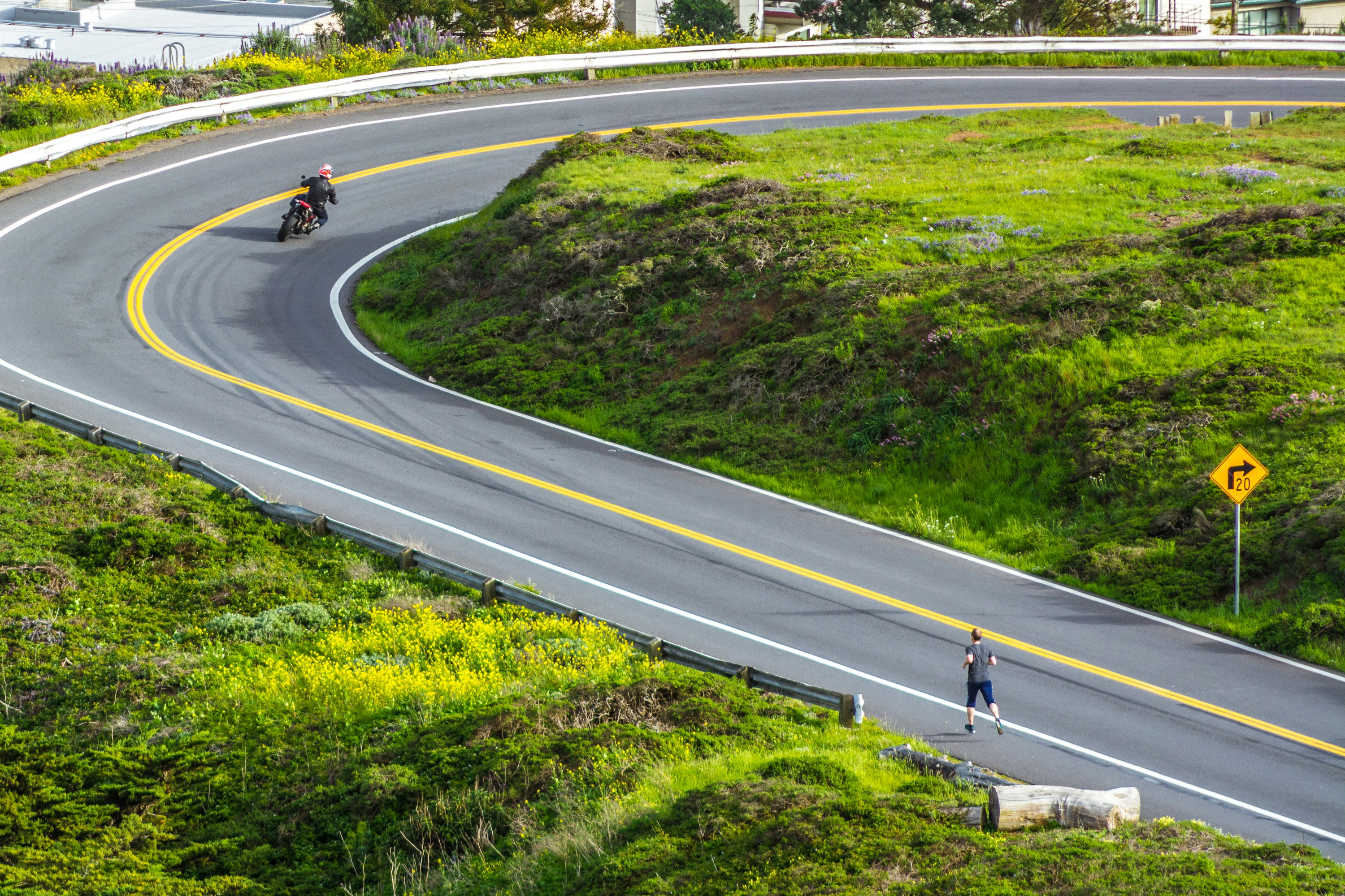 a person riding a motorcycle down a curvy road