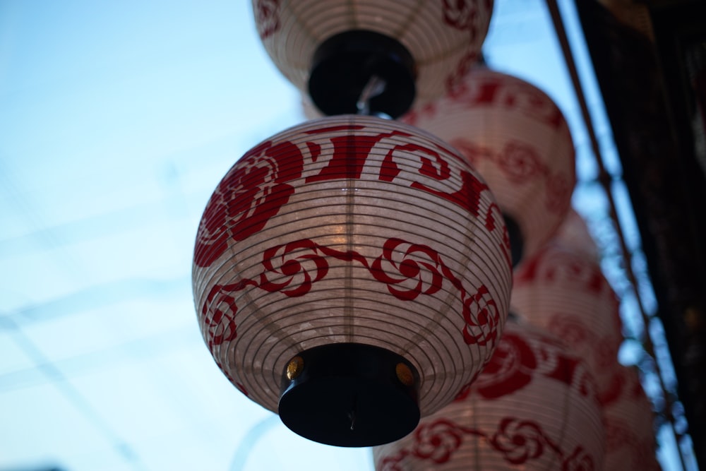 a close up of a red and white paper lantern