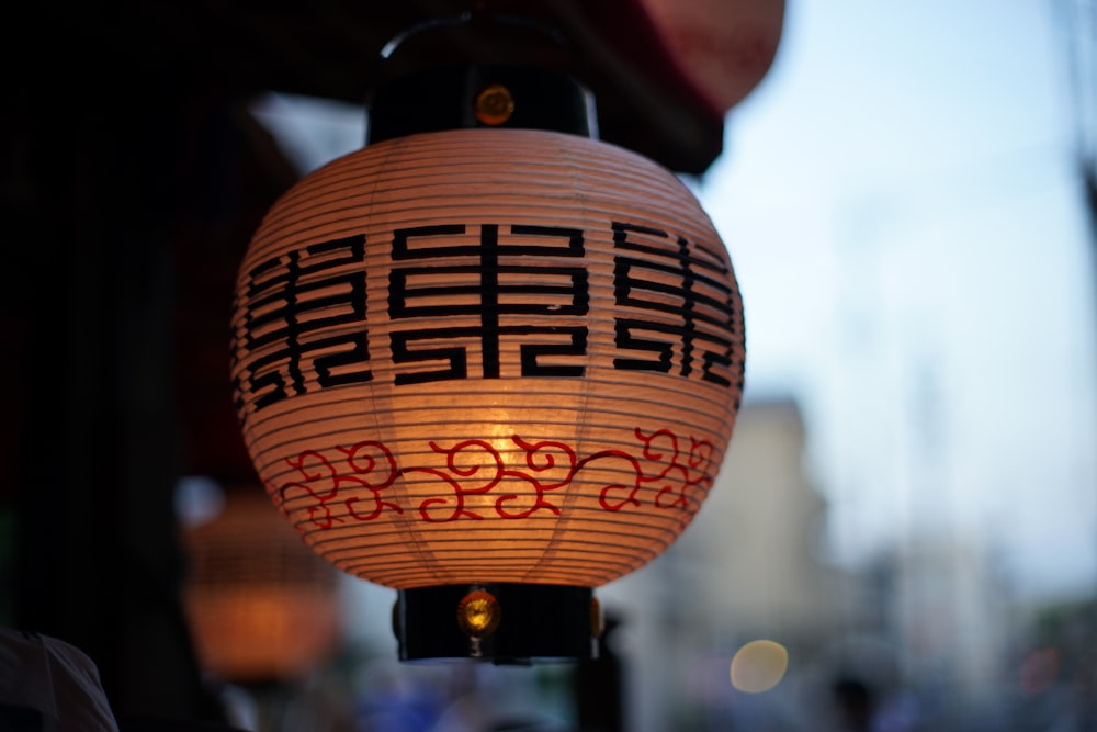 a chinese lantern hanging from a pole on a city street