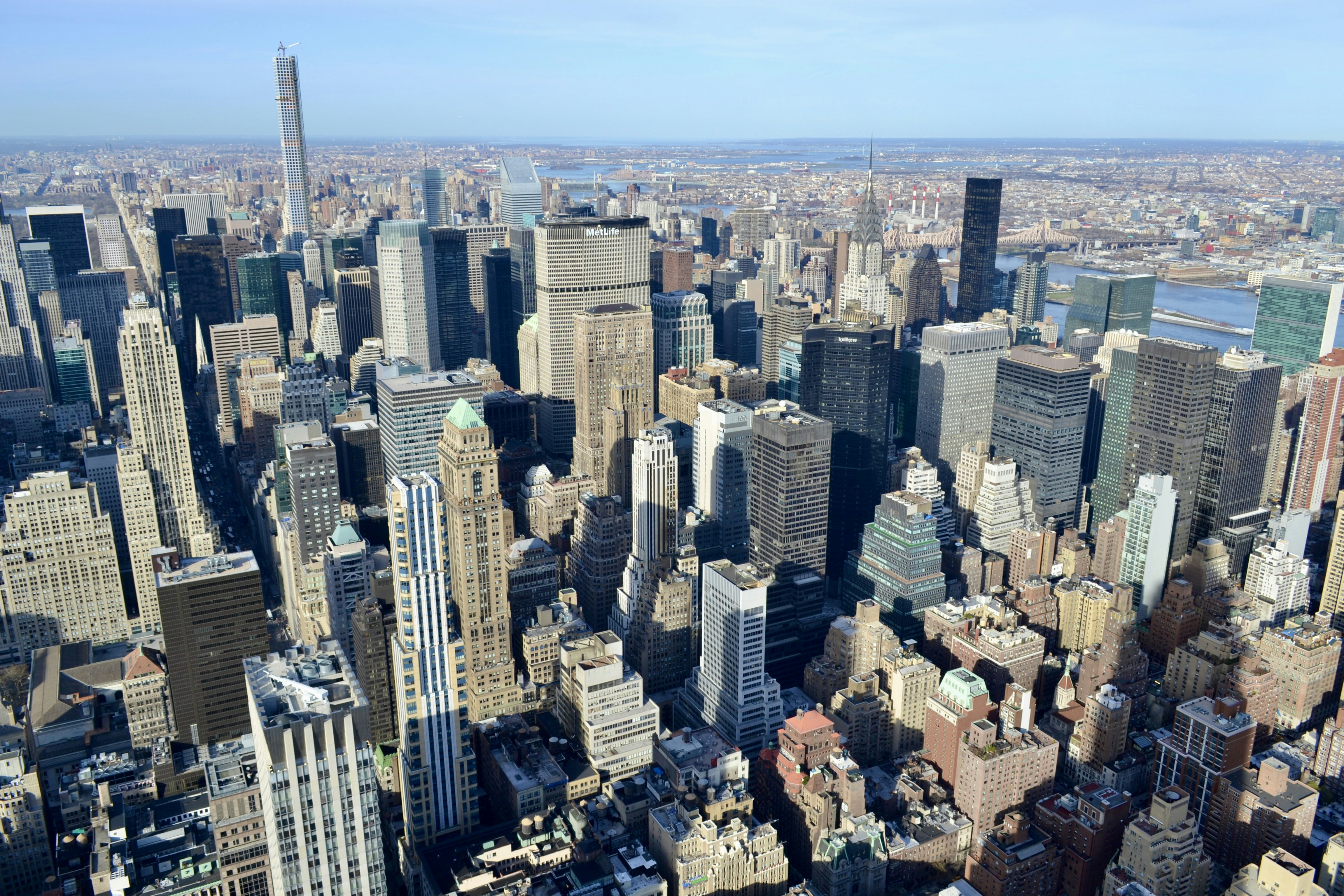 Aerial city map view of Manhattan skyline and street grid in bright daylight with clear blue sky