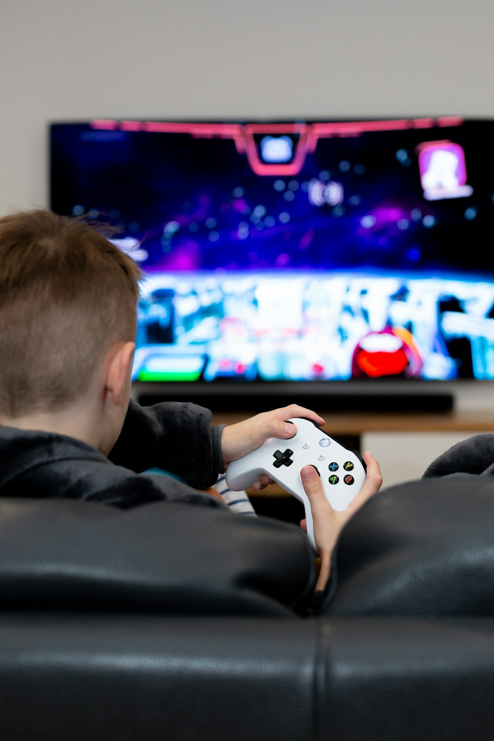 a young boy playing a video game on the nintendo wii