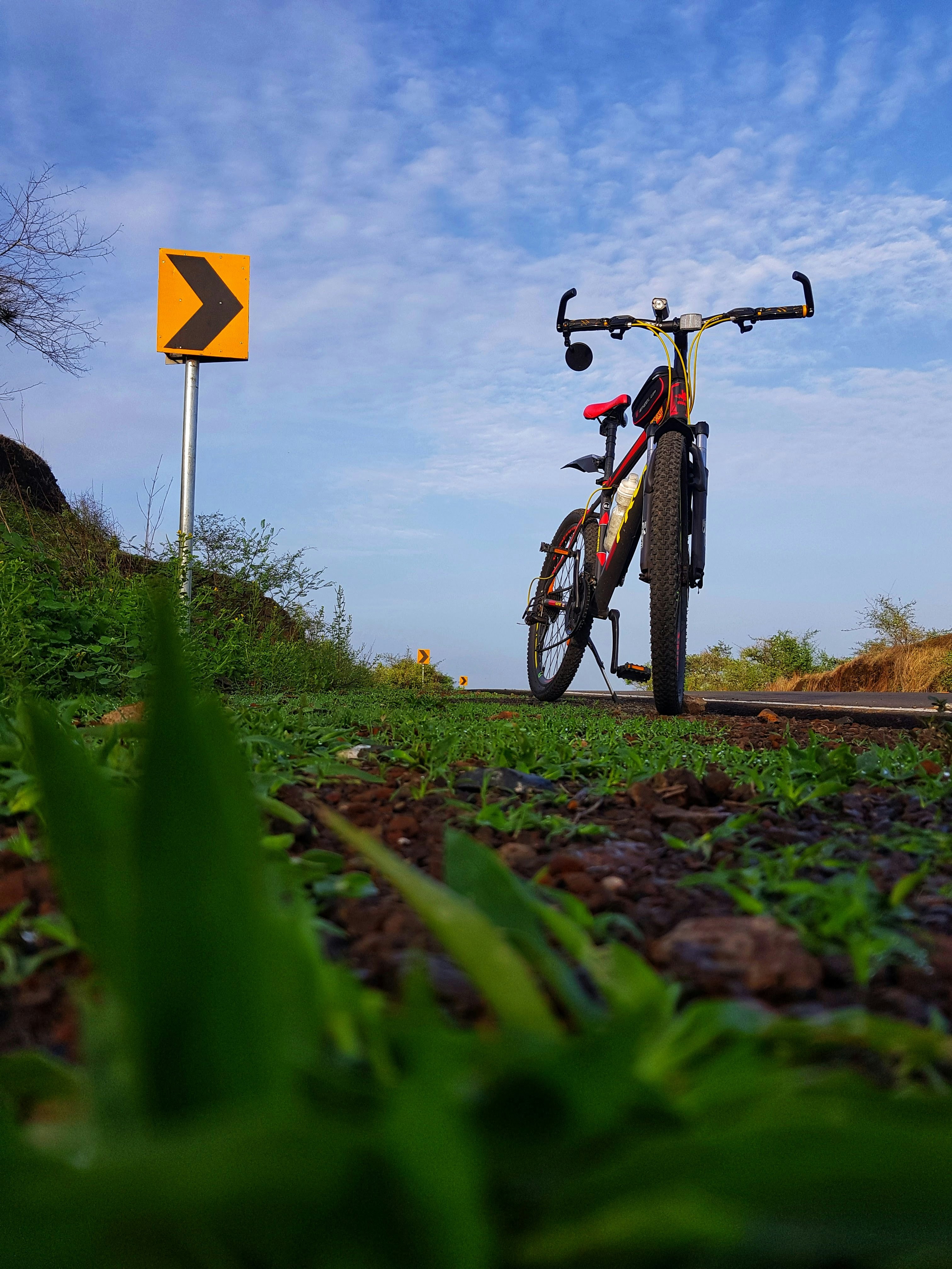 a bicycle parked next to a yellow sign