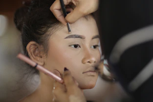 a woman getting her hair done by a professional hair stylist