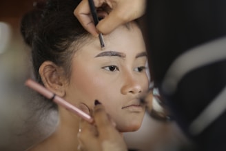 a woman getting her hair done by a professional hair stylist