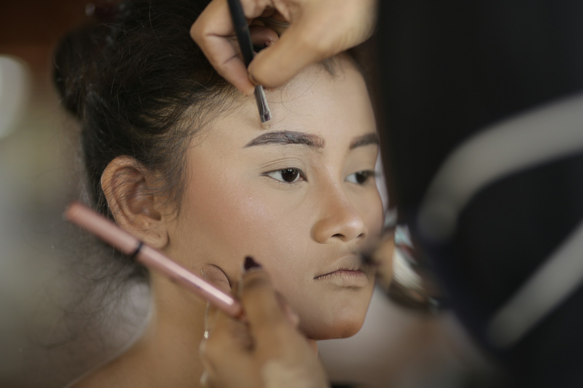 a woman getting her hair done by a professional hair stylist
