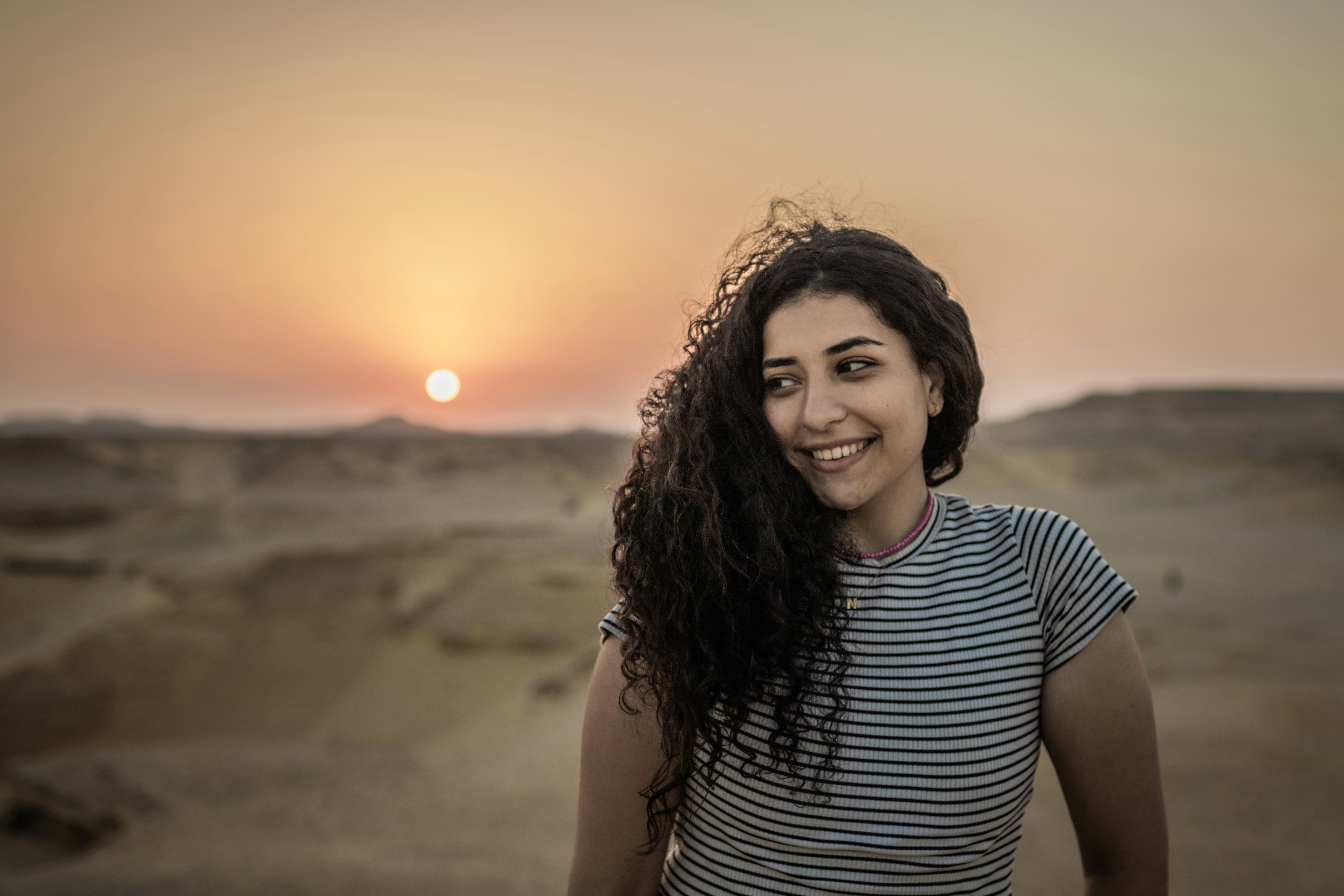 Egyptian girl with curly hair in the desert