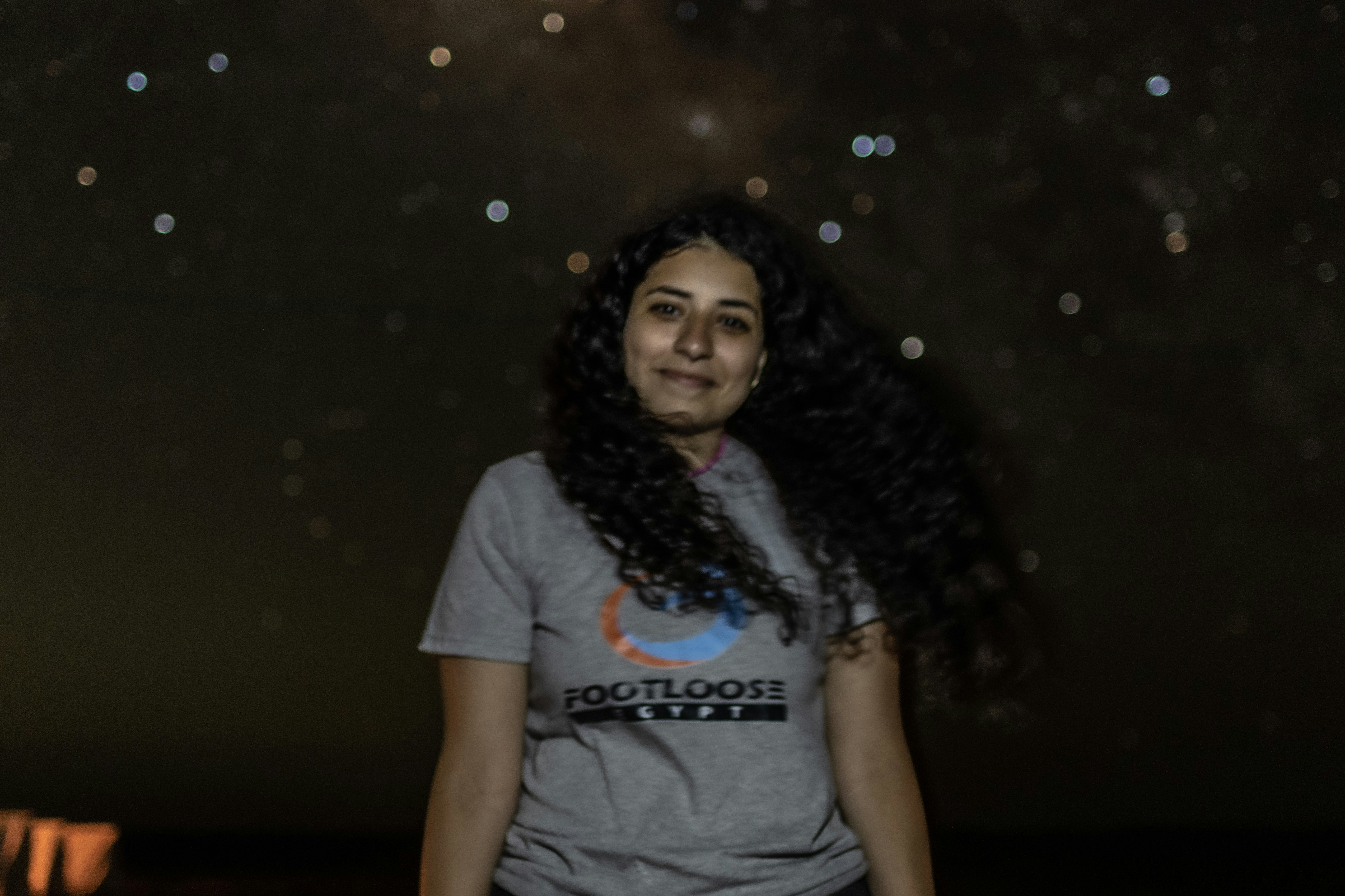 a woman standing in front of a sky full of stars