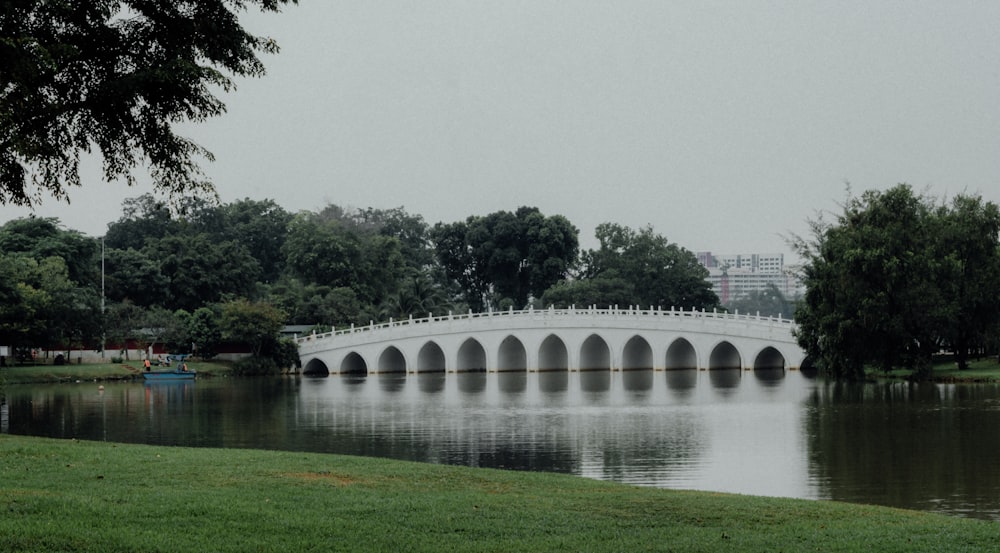 a white bridge over a body of water