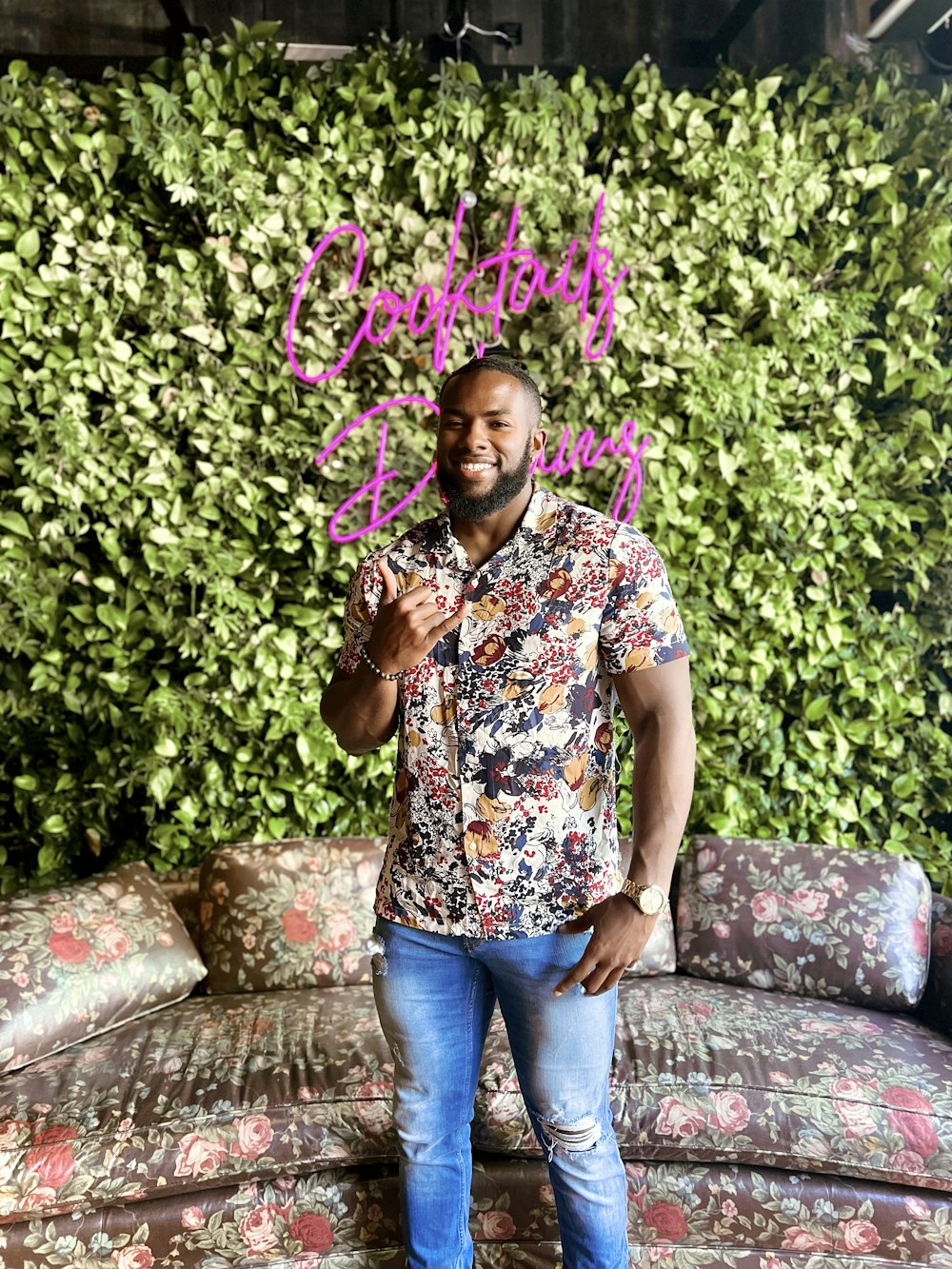 a man standing in front of a green wall