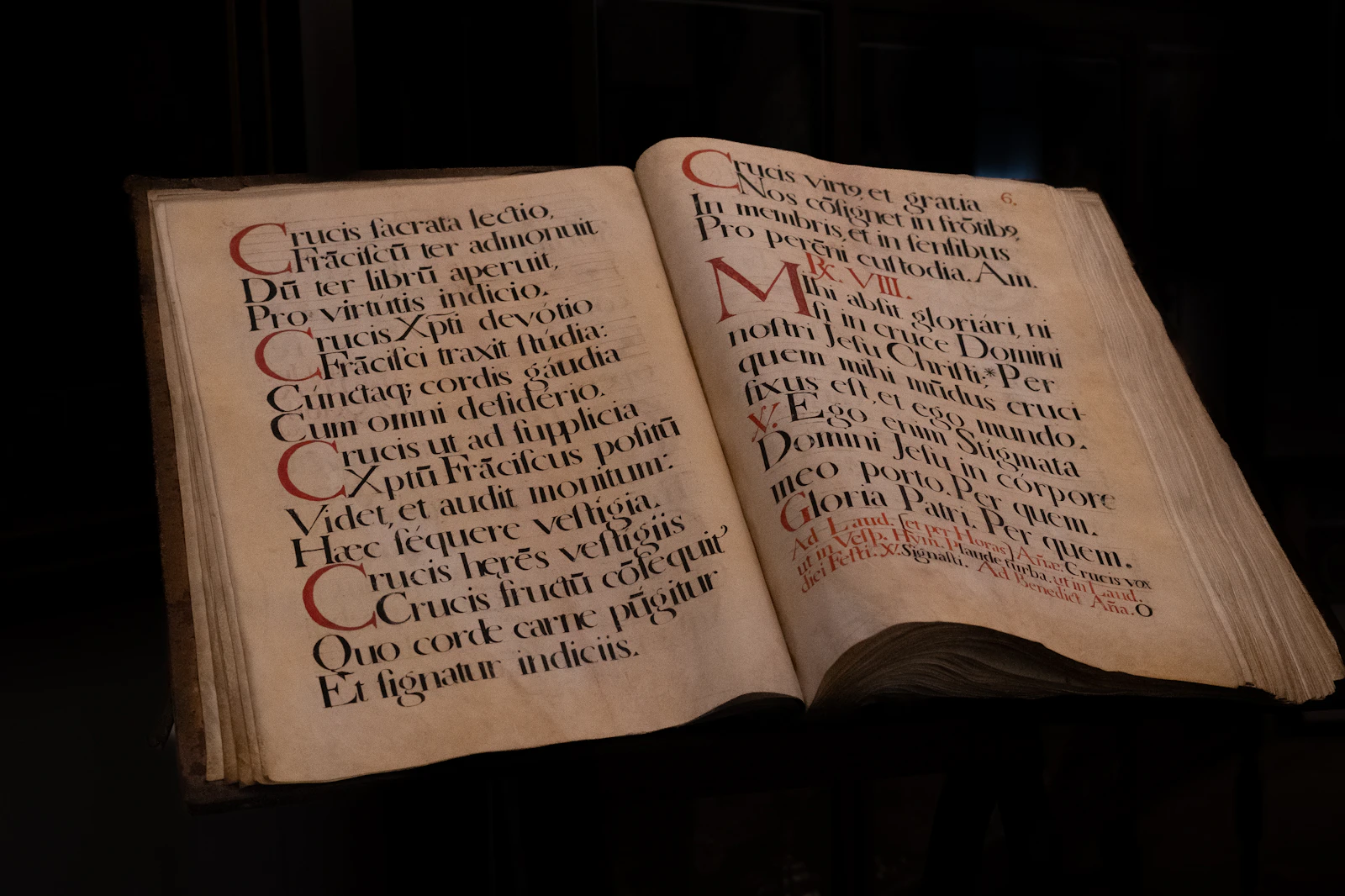 An open book with writing on it in a dim atmospheric room