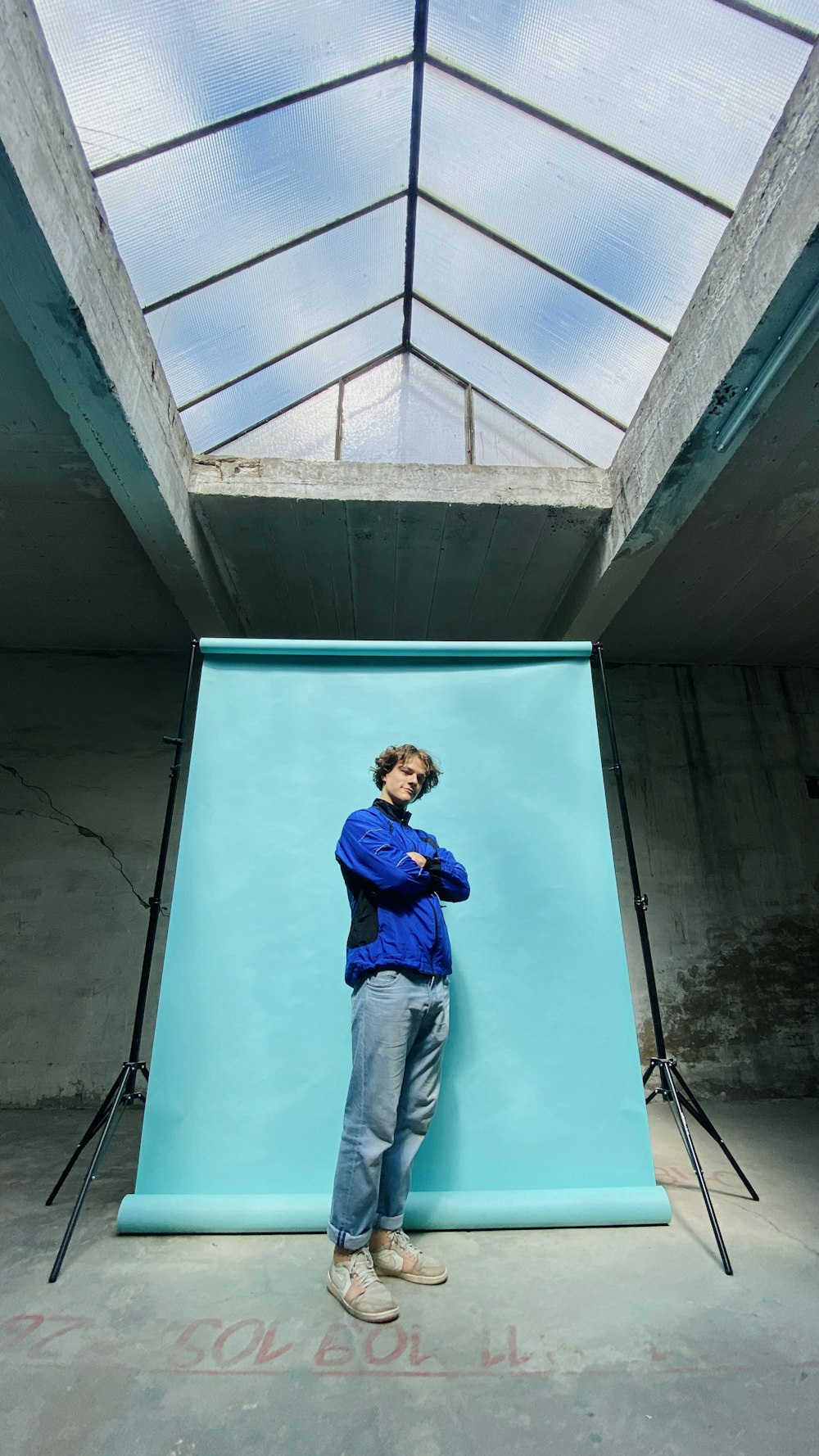 a man standing in front of a blue backdrop