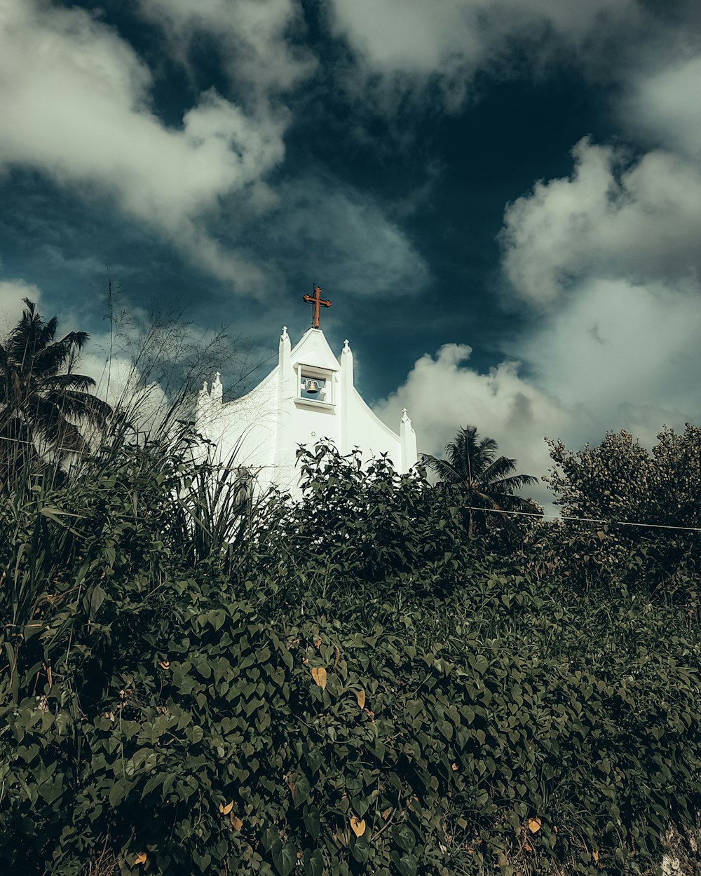 a white church with a cross on top of it