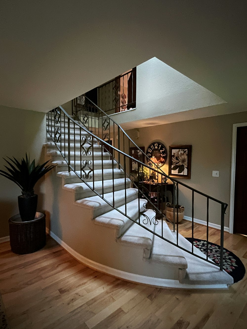 a staircase in a house with a potted plant next to it