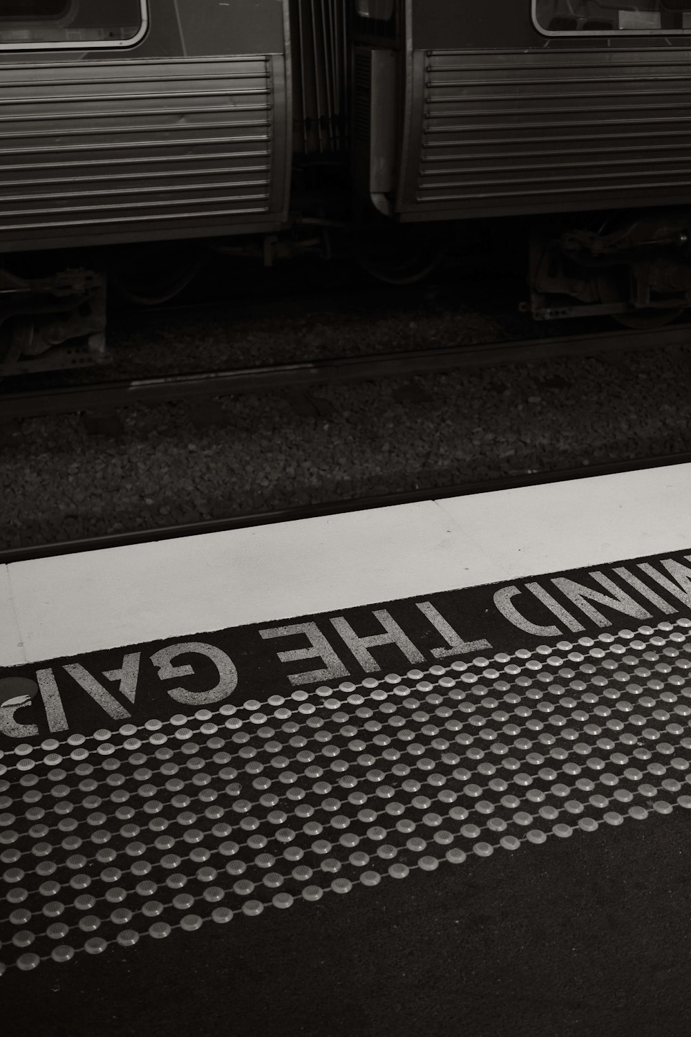 a black and white photo of a train at a station