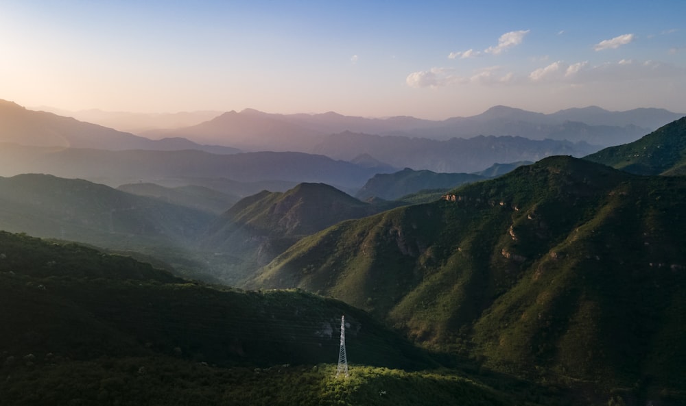 an aerial view of a mountain range at sunset